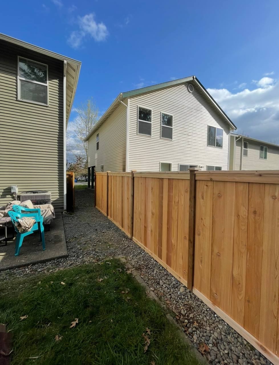 Capped cedar privacy fence along a side yard, Snohomish County