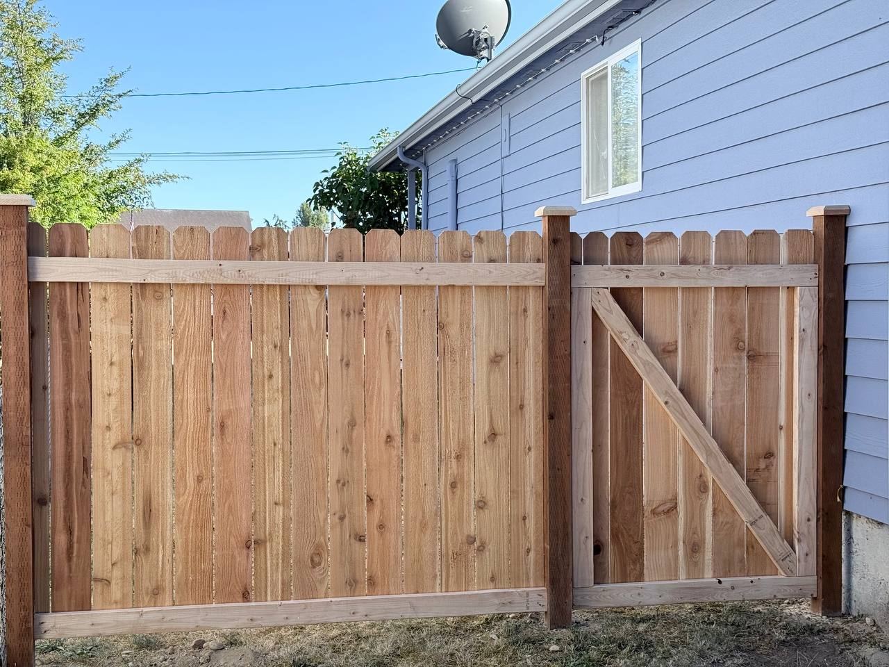 Dog-ear cedar picket fence with matching gate