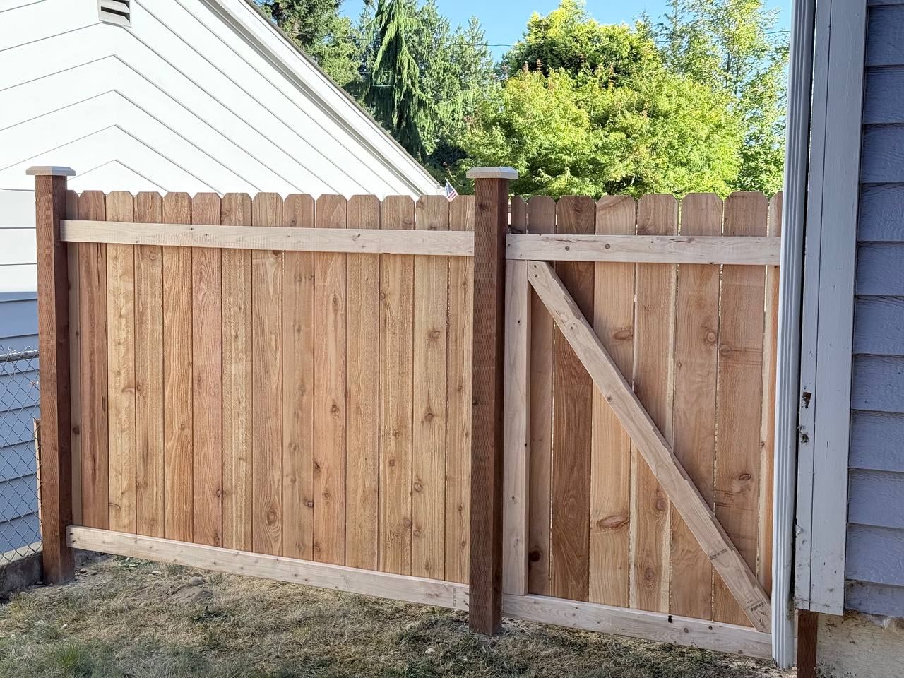 Cedar picket fence and gate between two homes